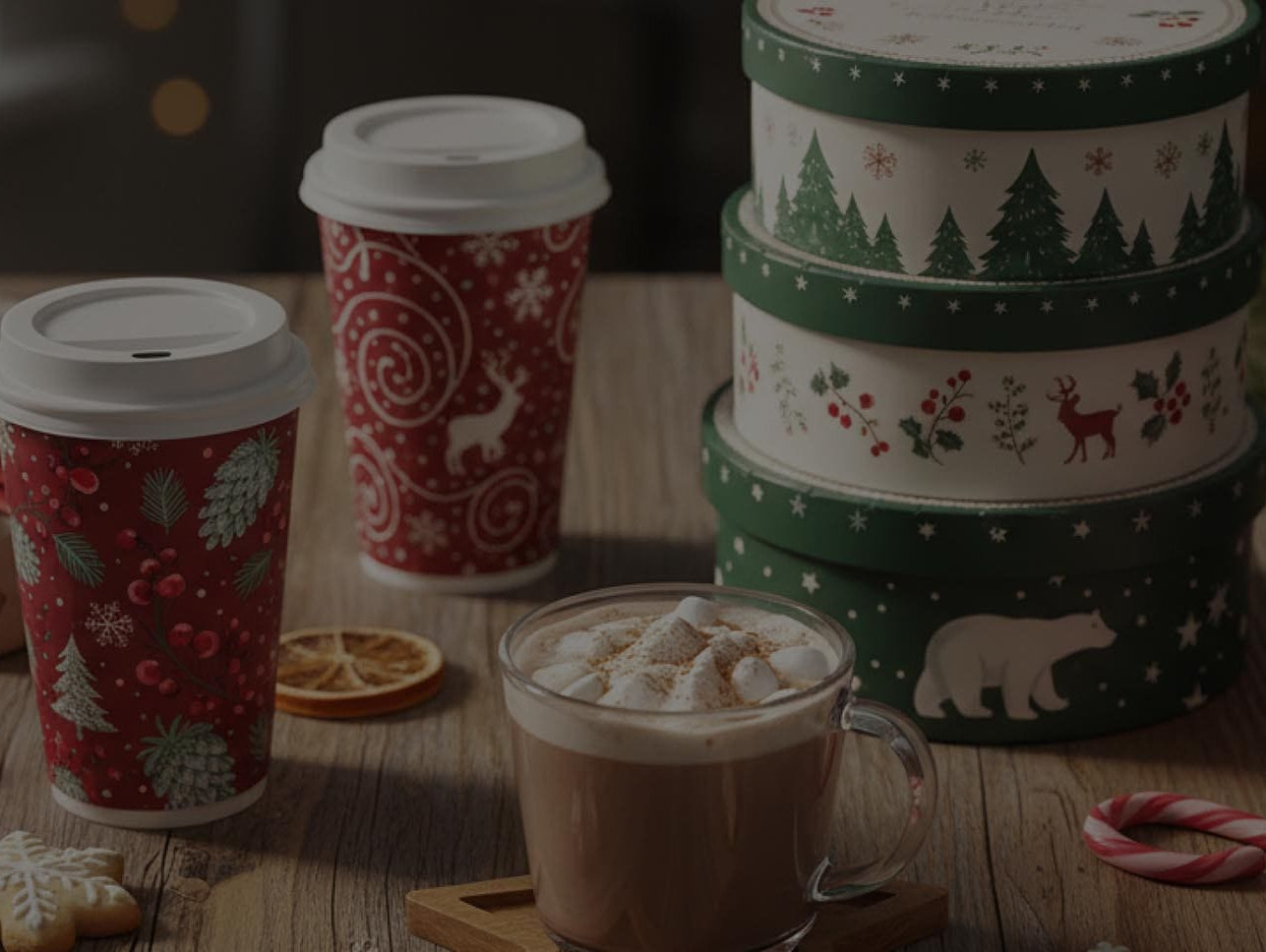 Decorative holiday mugs with festive designs on a wooden table.