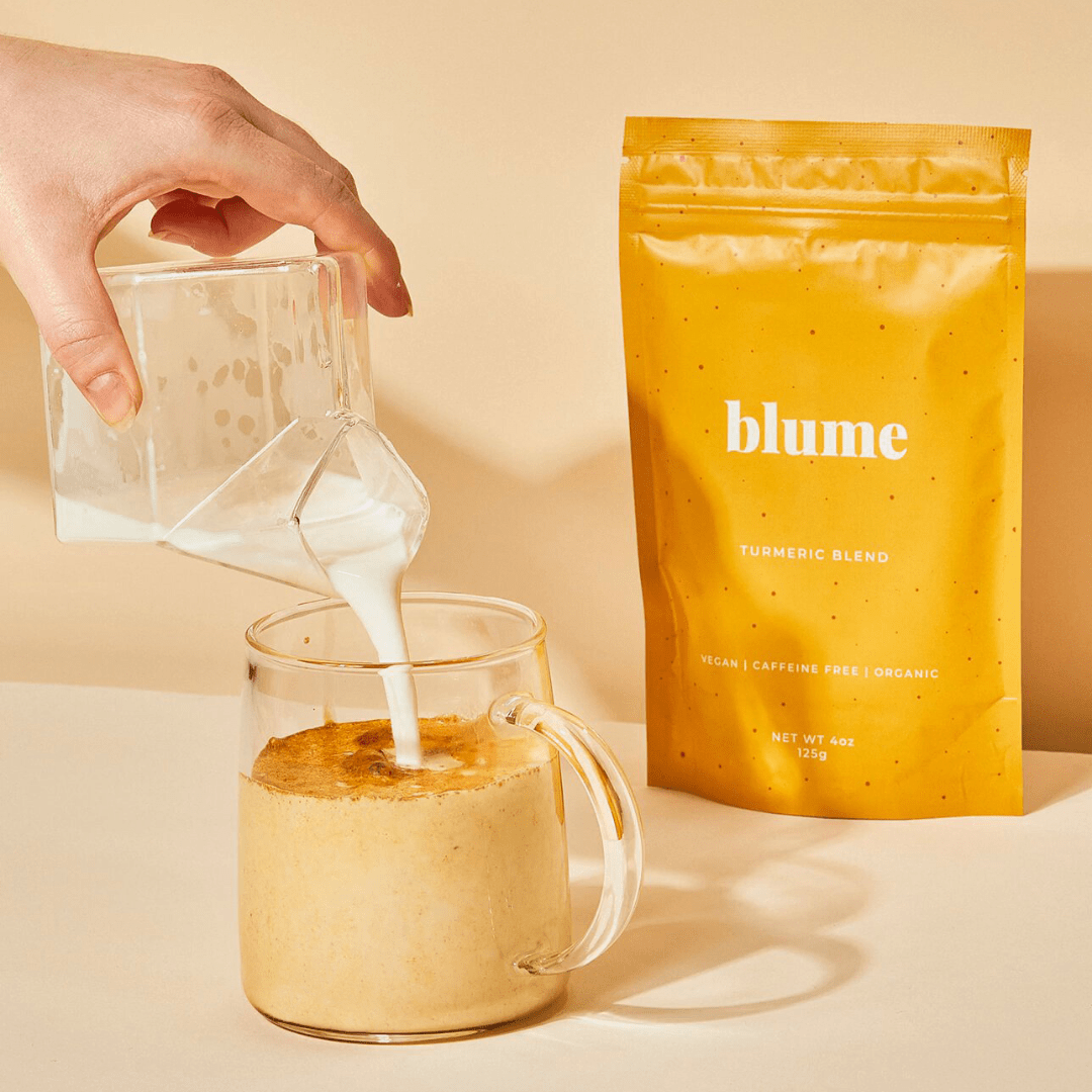 
                  
                    lifestyle image of a bag of blume turmeric latte blend and a person pouring milk into a glass 
                  
                