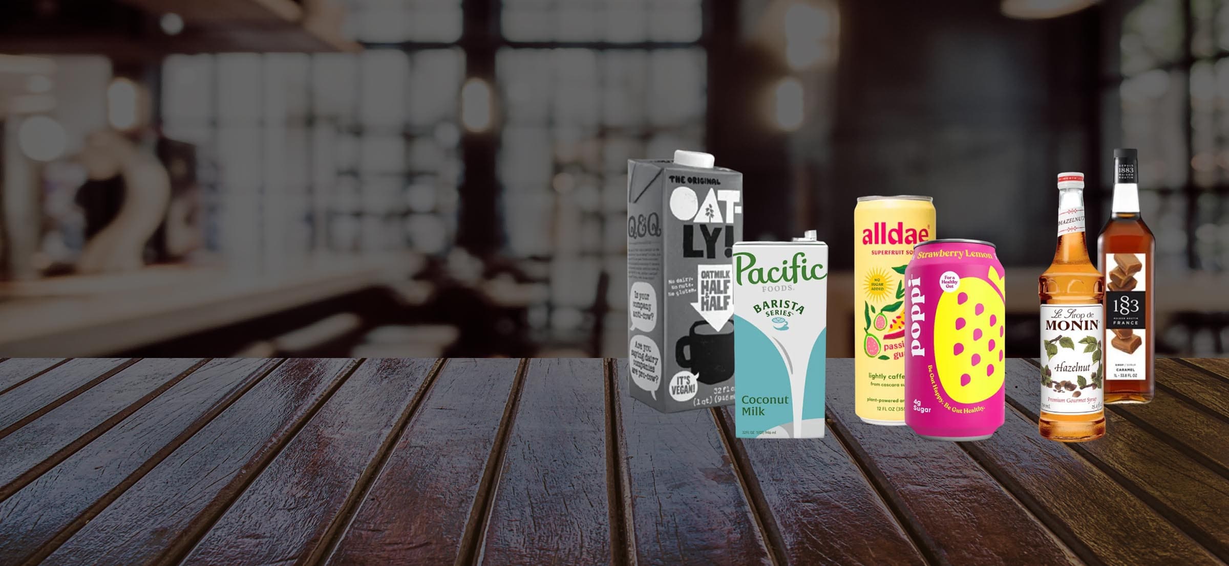 Various food products including cartons and bottles on a wooden surface with a blurred background.