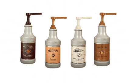 Four Monin syrup bottles on a green background with white lines.