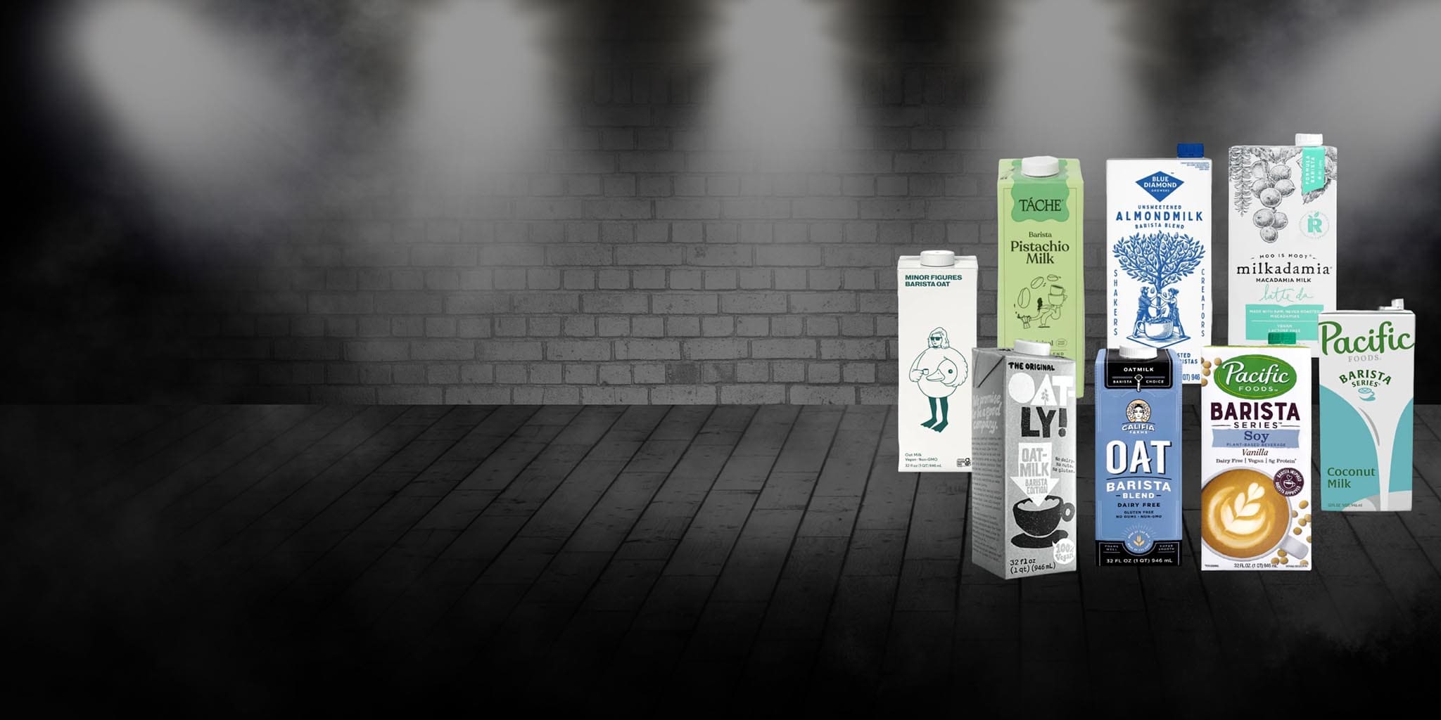 Various coffee and tea packages displayed against a dark brick wall.