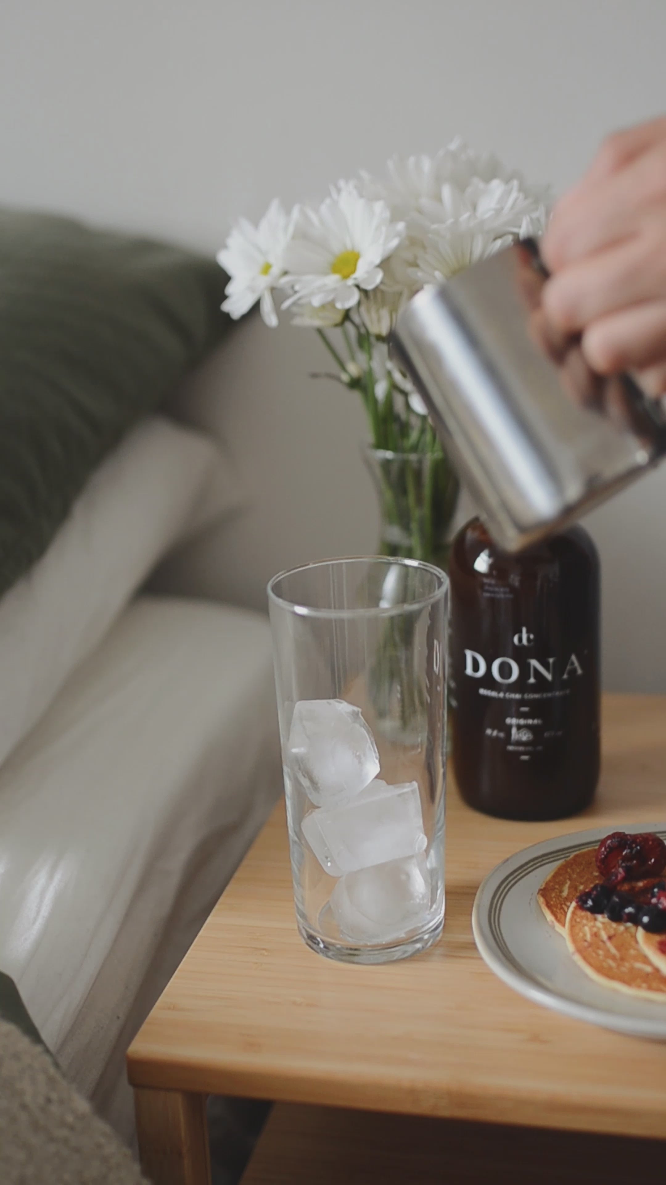 video of person pouring milk into a glass filled with ice